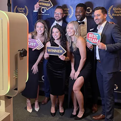 Guests holding Winner and Best Team signs at a Toronto photo booth