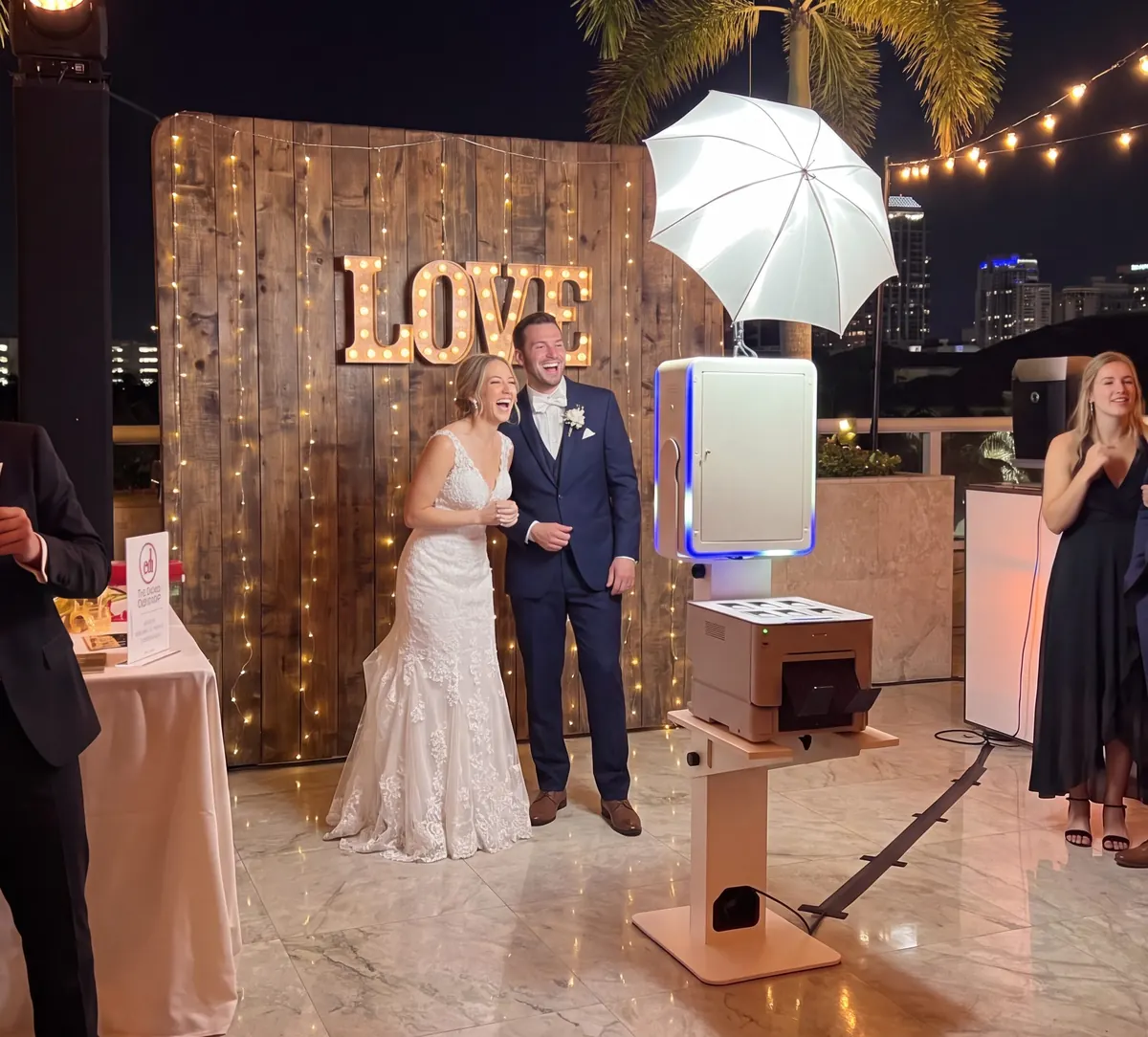 Luxury wedding photo booth with a light-up LOVE marquee